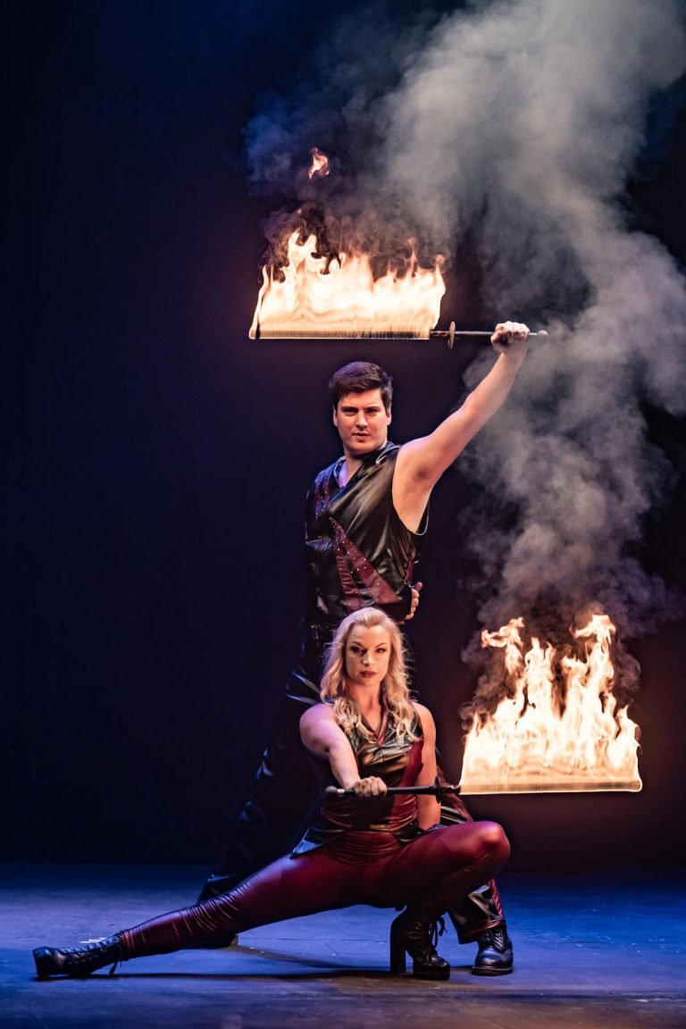 two fire performers posing during a fire show